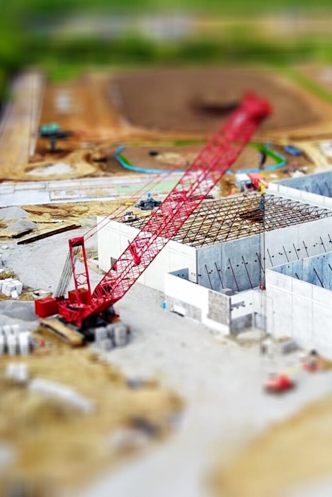 pexels-photo-392031-392031 Tilt Shift Lens Photography of Red Crane Miniature